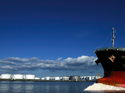 Ship moving past storage terminal