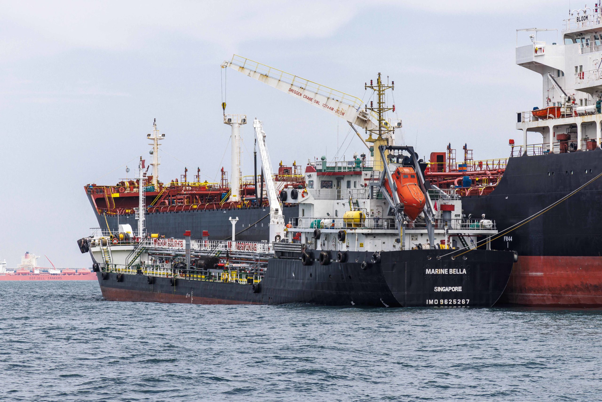 Bunker barge at sea refueling ship outside Singapore port