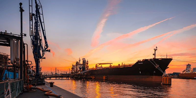 vessel at port with sunset sky