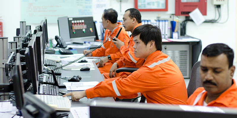 engineers overseeing logistics from main operations room with computer screens