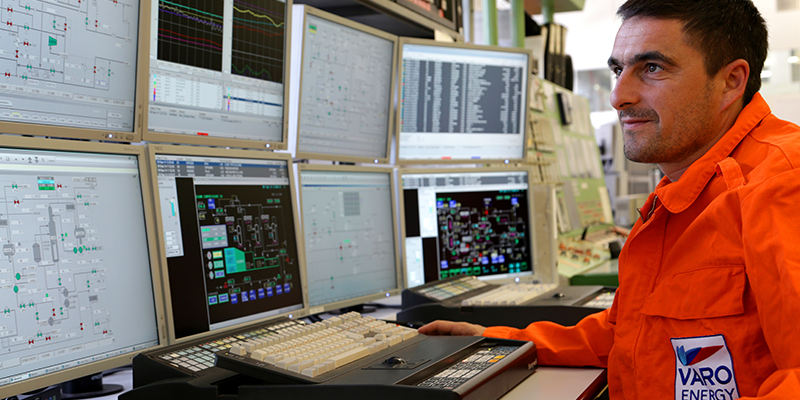 Engineer overseeing logistics at computer screen in main operations room