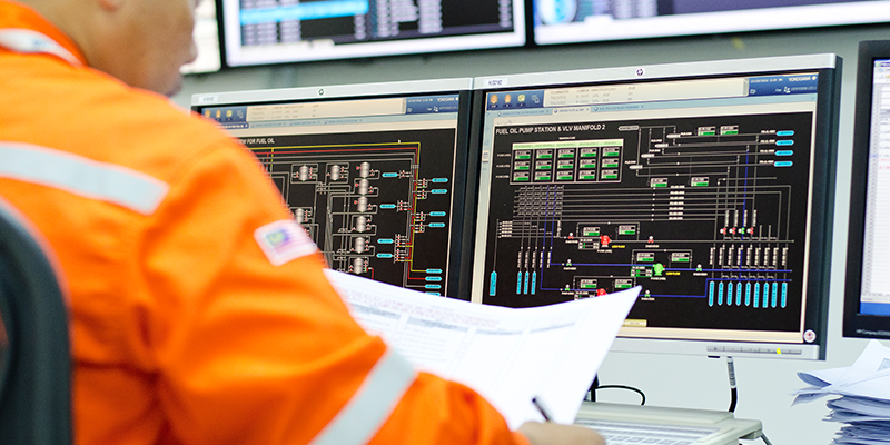 engineer at computer screen in terminal operations room