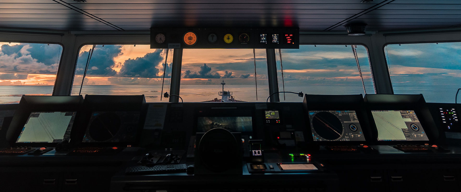 view from captains bridge on large ship at dusk