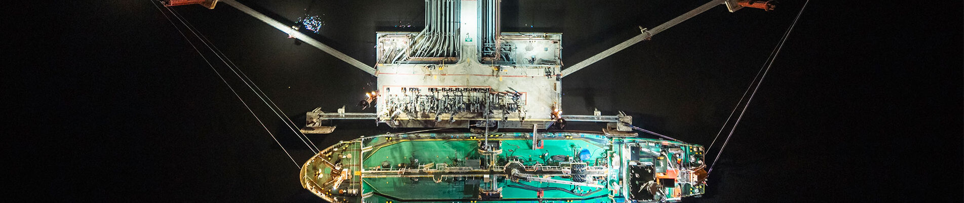 Bu nkering barge loading at jetty at night