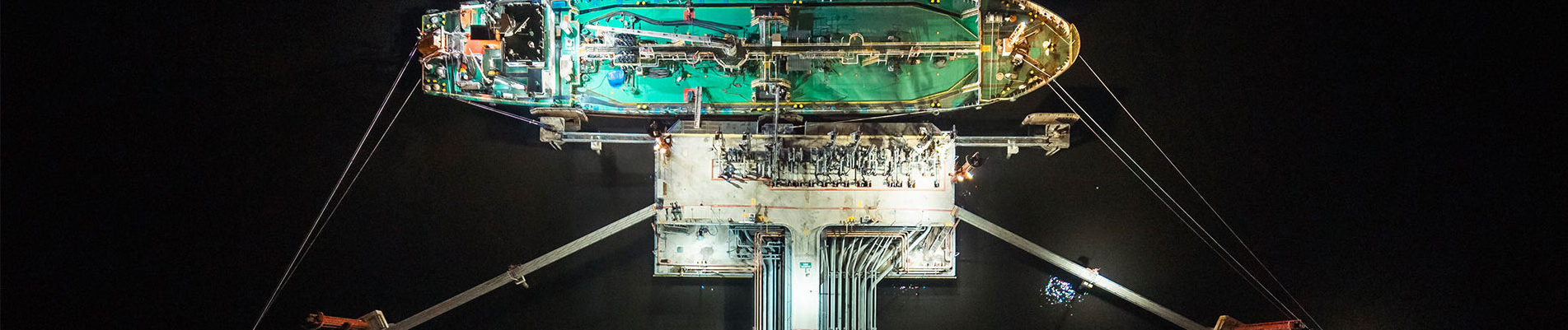 Bu nkering barge loading at jetty at night