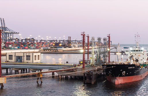 Bunkering barge loading marine fuels at jetty